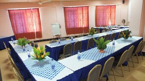 A conference room with long tables, blue tablecloths, and chairs. - Alcazar Hotel Kisumu (Kisumu)