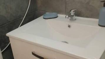 Een haardroger, handdoeken, zeep, toiletpapier