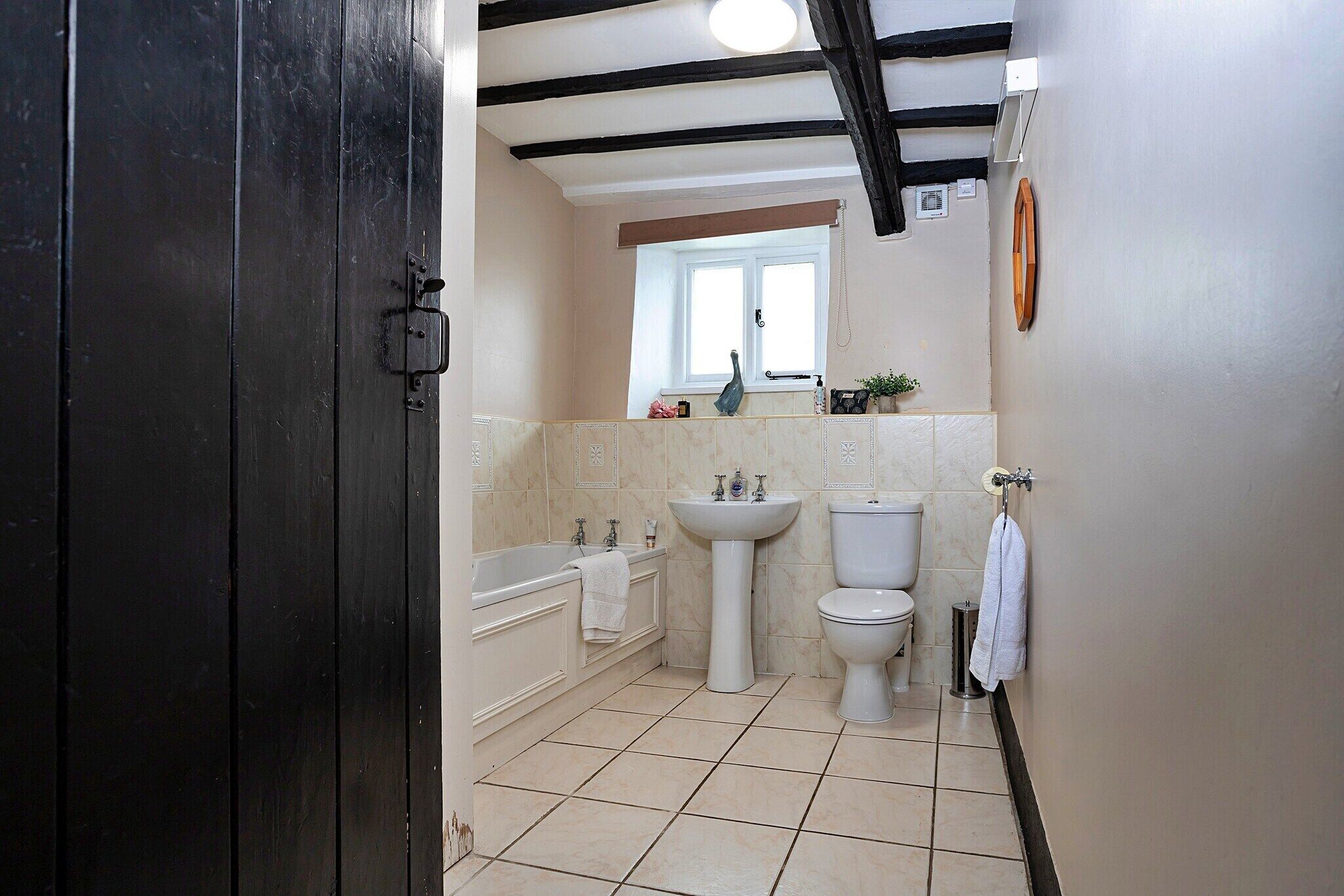 A bathroom with a bathtub, sink, and toilet.