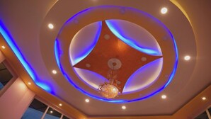 A ceiling with a circular design, recessed lighting, and a chandelier. - Pink Park By Panache Hotel (Bir)