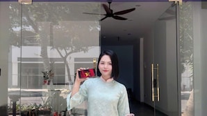 A woman standing in front of a building with a sign that reads "IS OTIS APARTMENT". - LOUIS OTIS APARTMENT (Da Nang)