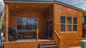 A wooden cabin with a porch, a covered seating area, and a staircase leading to the entrance. - Chalet w 2nd Floor | Pool, Hot Tub (Breckenridge)