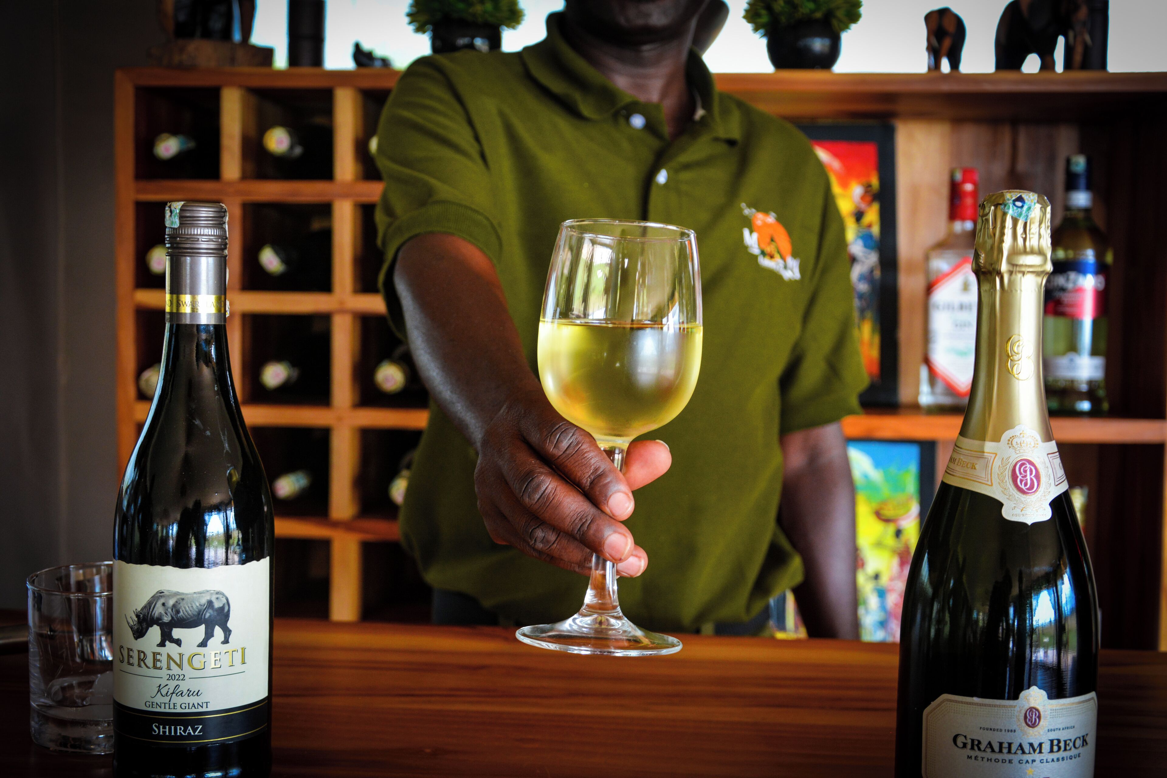 A wine bottle labeled 'Serengeti' and a glass of white wine.
