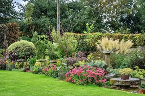 Stroll through the serene garden, surrounded by vibrant blooms and lush greenery.