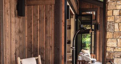 This idyllic Suncadia home features a speakeasy, cowboy cold dip, outdoor shower, private library, chef's kitchen, golf course views, and MORE