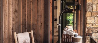 This idyllic Suncadia home features a speakeasy, cowboy cold dip, outdoor shower, private library, chef's kitchen, golf course views, and MORE