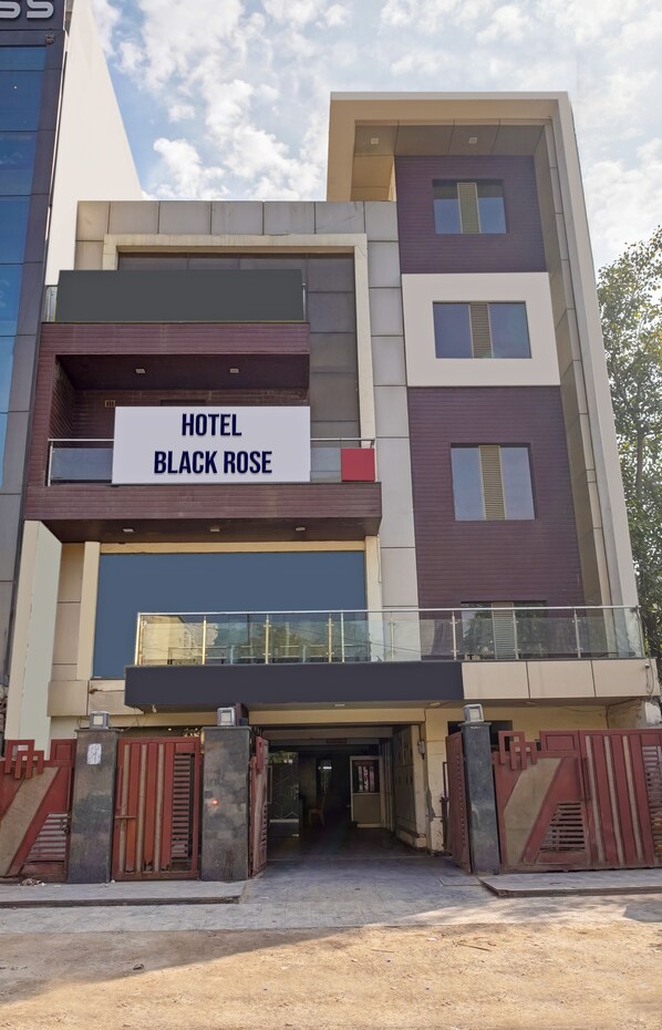 A modern hotel named "Hotel Black Rose" with a prominent sign, a multi-story structure, and a gated entrance. - Hotel Black Rose  (New Delhi)