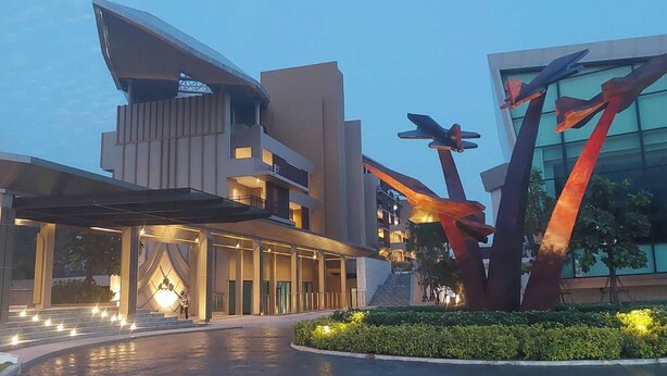 A modern hotel with a unique architectural design, featuring a prominent sculpture in the foreground and a well-lit entrance. - The Grand Chaiyapruek Nimman Chiangmai (Chiang Mai)
