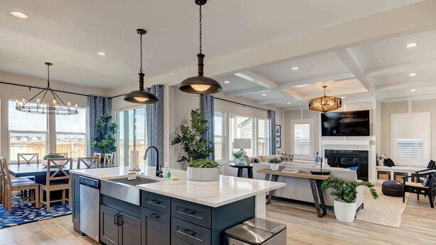 A modern kitchen with a central island, stainless steel appliances, and pendant lighting. - Spacious 4BR Retreat Near Bozeman (Belgrade)
