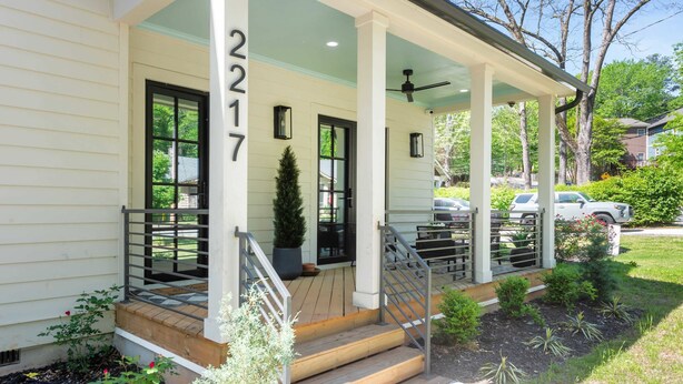 A house with a porch, number 2217, and a small garden area.