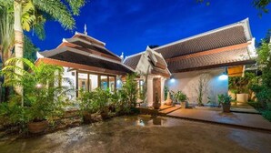 A traditional building with a tiled roof and a small pond in the center. - Balinese-inspired 3-bedroom villa with private pool, garden, and 5-min walk to Bang Kao Beach (Koh Samui)