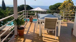 An outdoor patio with a table and chairs, a pool, and a view of the ocean. - Intimate Family Villa with big private pool & panoramic sea view (CT)