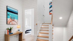 A staircase with wooden steps and white walls.