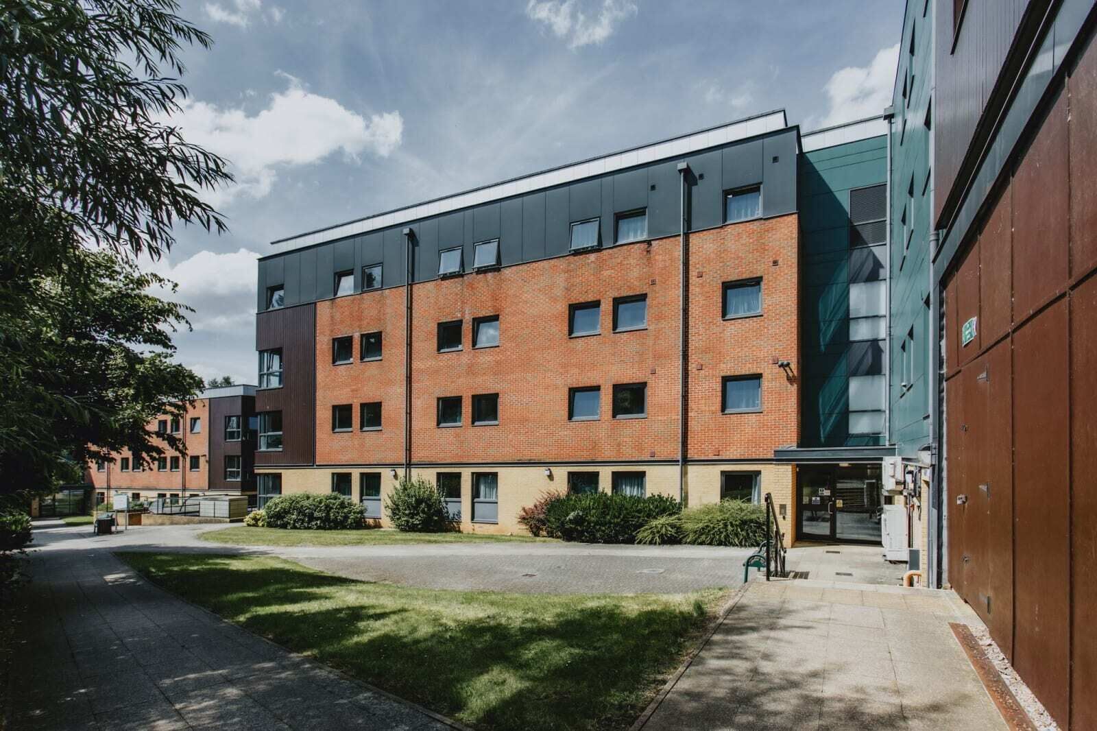 A multi-story building with a brick facade and large windows.