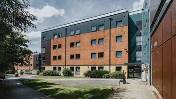 A multi-story building with a brick facade and large windows.