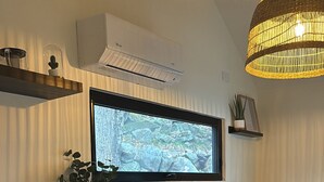 Une cuisine moderne dotée d’un four encastré, d’un four à micro-ondes et d’une grande fenêtre offrant une vue sur l’extérieur.