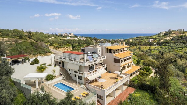 A modern villa with a swimming pool, multiple balconies, and a view of the sea. - Casa Barbara (Chania)