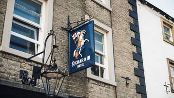Letrero del Hotel Richard III con un escudo de armas y la figura de un caballero.