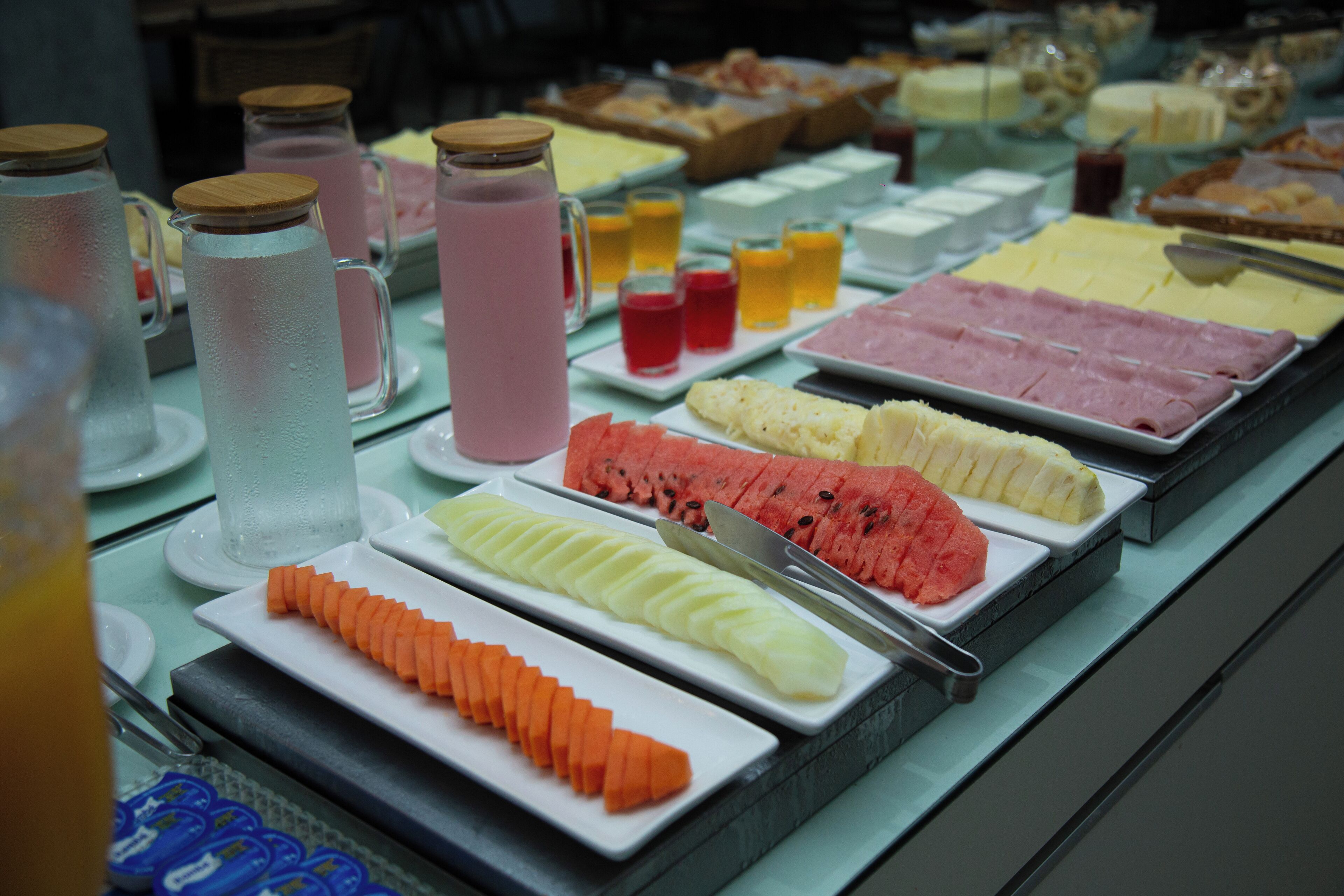 A buffet with various food items and beverages.