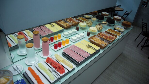 A buffet with various food items and beverages.