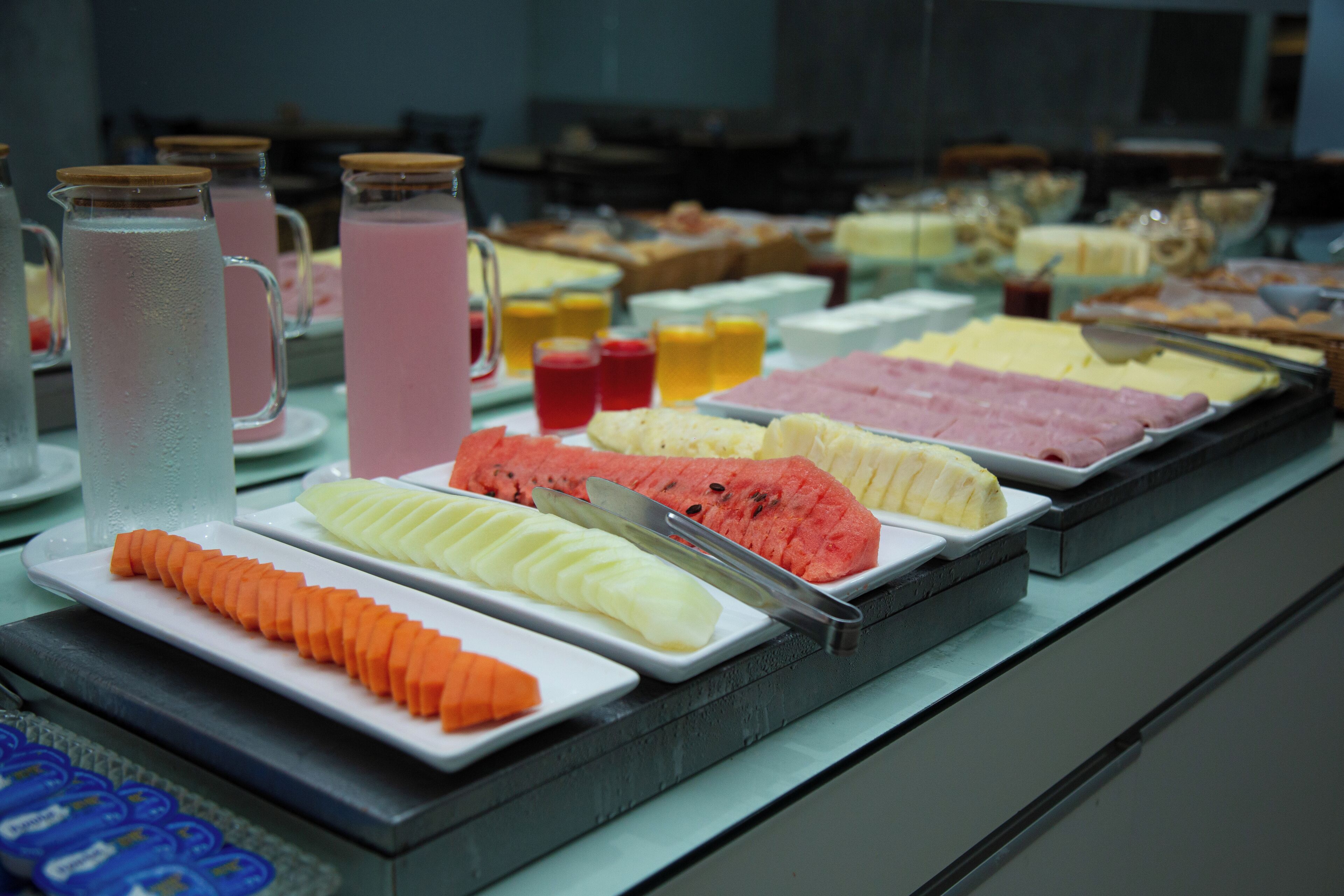 A buffet with various food items and beverages.