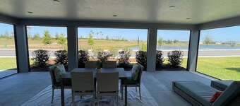 Stunning new home with water view, screened lanai & golf cart!
