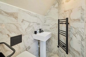 Shower, hair dryer, towels, shampoo