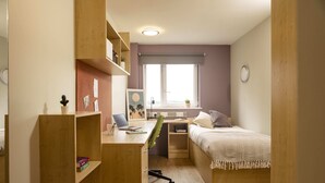 A compact room with a desk, a bed, and a window. - Belgrave View - Campus Accommodation (Birmingham)