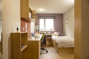 A compact room with a desk, a bed, and a window. - Belgrave View - Campus Accommodation (Birmingham)