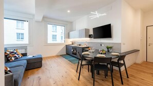 A modern apartment with a dining area, kitchen, and living space. - Central Apartment Piazza Dante Genova (Genoa)
