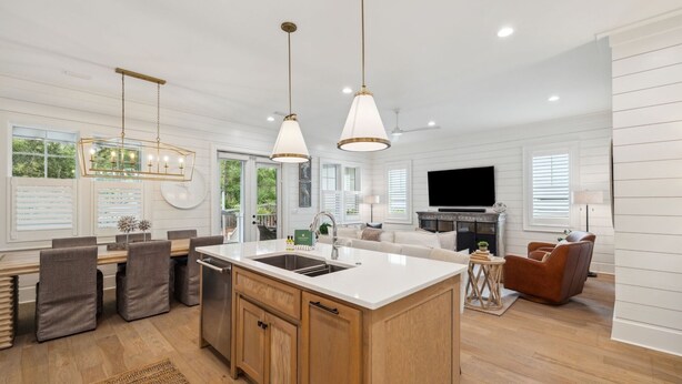 A modern kitchen with a central island, wooden cabinets, and pendant lighting. - Private Pool | LSV | Bikes (Santa Rosa Beach)