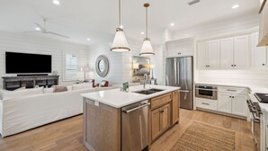 A modern kitchen with white cabinetry, stainless steel appliances, and a central island. - Private Pool | LSV | Bikes (Santa Rosa Beach)