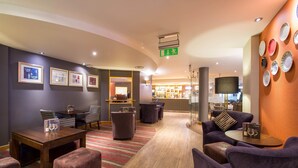 A hotel lobby with a reception desk, seating area, and a bar. - Premier Inn Liverpool City Centre - Moorfields (Liverpool)