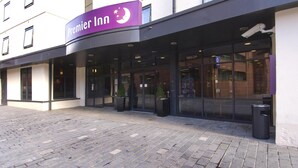 A Premier Inn hotel entrance with a clear glass facade, a signboard, and a paved walkway. - Premier Inn Liverpool City Centre - Moorfields (Liverpool)