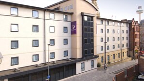 A hotel with multiple floors, a prominent 'Premier Inn' sign, and a clock tower in the background. - Premier Inn Liverpool City Centre - Moorfields (Liverpool)