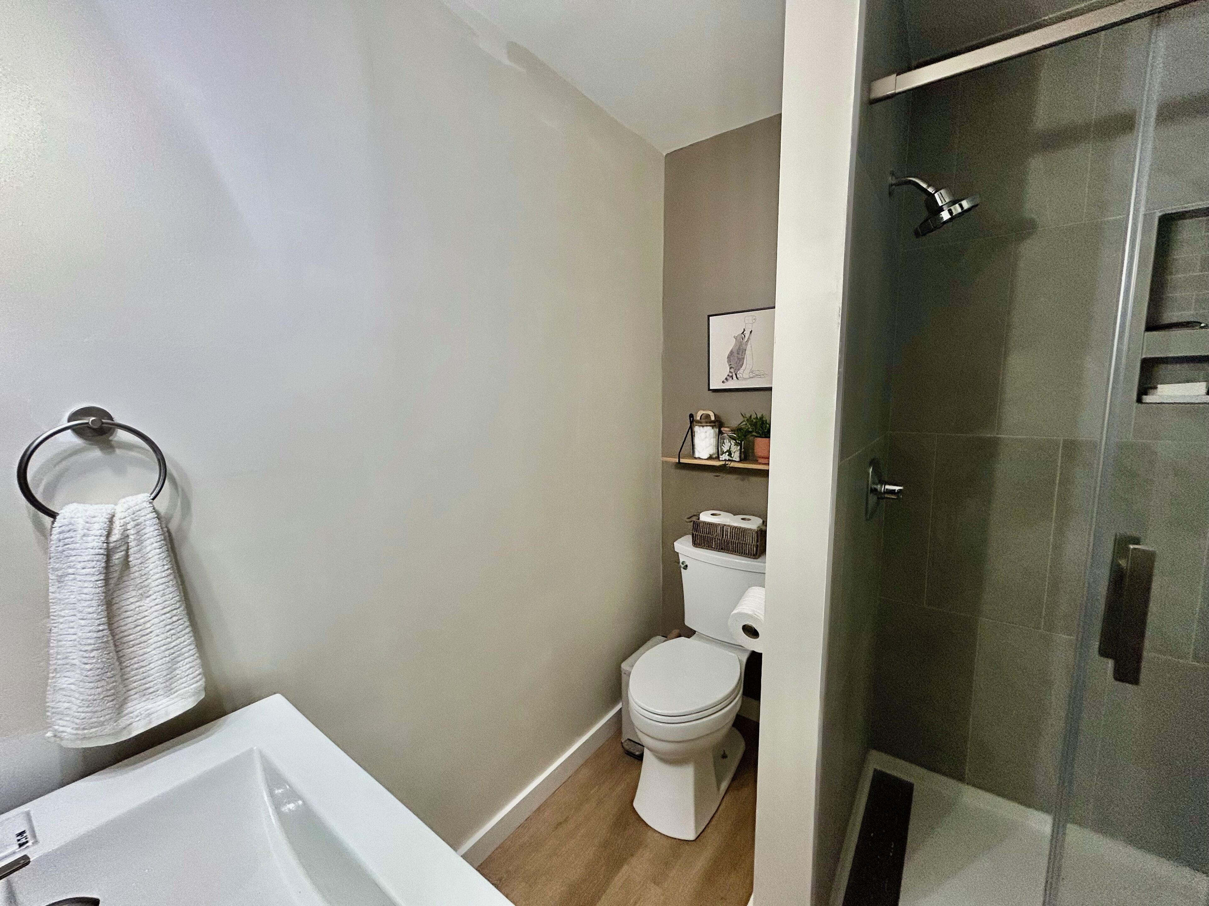 Une salle de bain avec des toilettes, une douche et un lavabo.