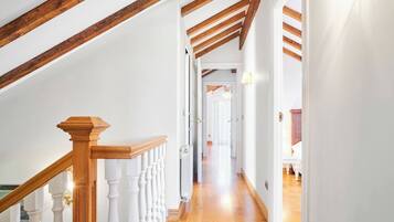 A wooden staircase with white balusters leading to an upper floor.