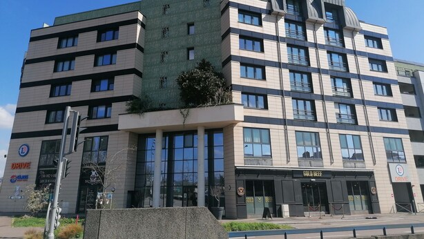 A multi-story building with a modern architectural design, featuring large windows and a green facade. - Terres de France - Appart'Hôtel Rouen Flaubert (Rouen)