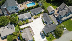 Une vue aérienne d’un quartier résidentiel avec plusieurs maisons, une piscine et une allée.
