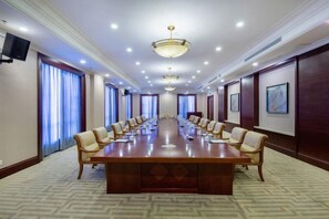 A conference room with a long table, chairs, and a projector screen. - Jinzhai Hongfu Garden Yuehai Hotel (Dabie Mountain Yuboyuan) (Jinzhai)
