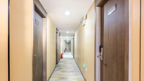 A hotel corridor with doors on both sides, a patterned floor, and emergency equipment. - Super 8 Hotel (Liujiayao Metro Station) (Beijing)
