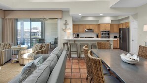 A modern kitchen with wooden cabinets, stainless steel appliances, and a central island. - Lake View Villa at Hidden Dunes! (Miramar Beach)