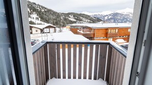 A balcony with a wooden railing and a snow-covered ground. - Apartment in Katschberghohe Near Ski Slopes (Rennweg am Katschberg)