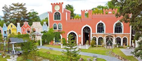 A castle-like building with a clock tower, arched windows, and a sign reading "Castle Town."