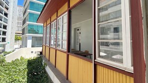 A modern building with large windows and a wooden facade. - Hotel El Rinconcito Acogedor (Santiago)