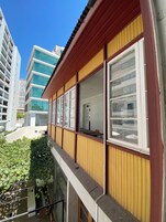 A modern building with large windows and a wooden facade.