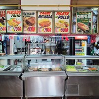 A food service area with various food options and prices displayed.