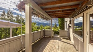 A covered wooden deck with a view of mountains and trees. - Delightful 2-bedroom apartment in charming Lillehammer (Innlandet)