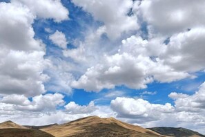 A landscape with rolling hills and a clear sky with clouds. - Crown Boutique Hotel (Sertar)