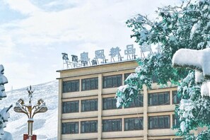 A multi-story building with a sign on the roof. - Crown Boutique Hotel (Sertar)